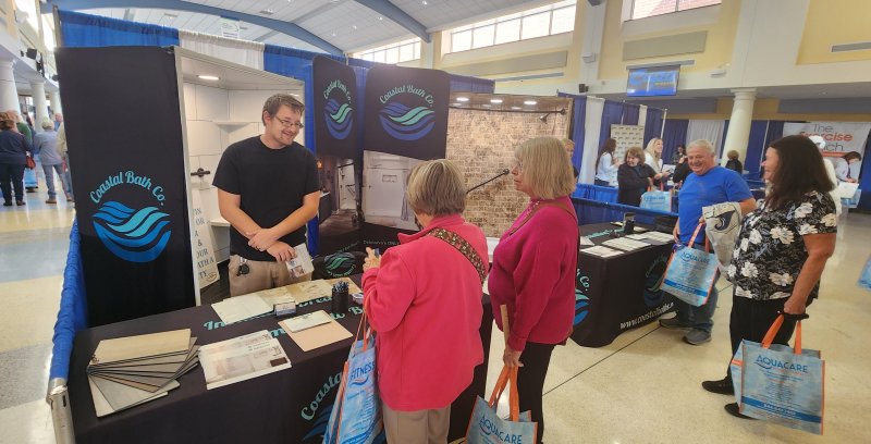 Jeffrey Imbragulio of Coastal Bath greets visitors at his booth at the 55+ Expo.